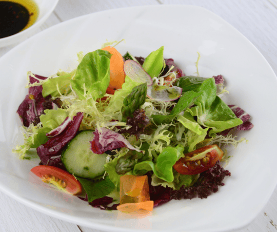 colorful detox salad with fresh vegetables and a light dressing.
