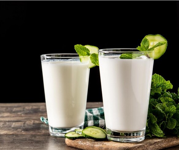 A glass of kefir with a fresh mint.